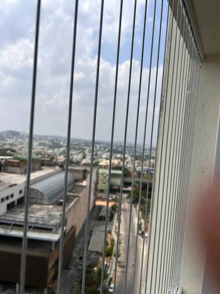 Horizontal invisible grill wires fitted over an open-to-sky courtyard