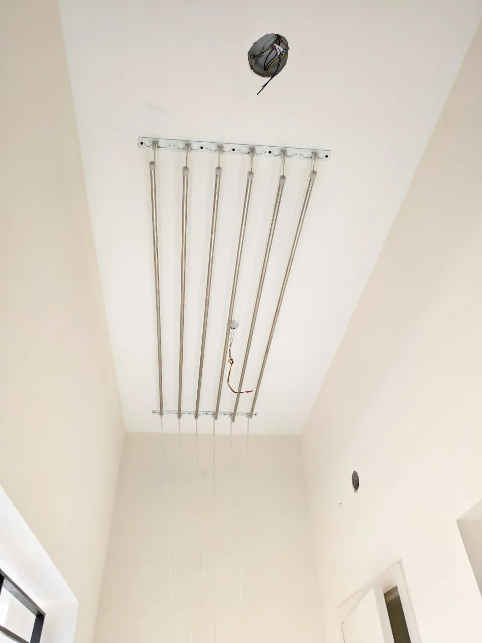 Stainless steel pulley cloth hanger fixed to a high utility ceiling